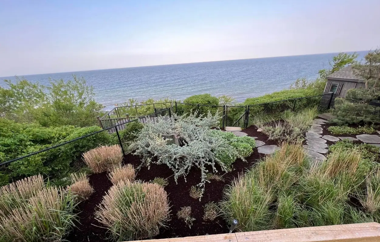 Backyard cleanup and mulch installation with refreshed beds in Plymouth MA