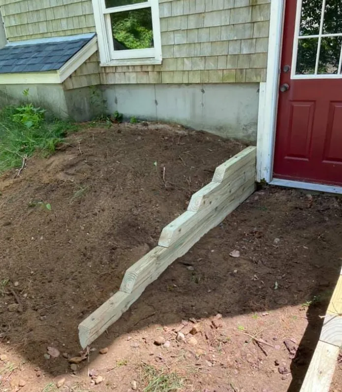 Timber edging and grade support near Plymouth home